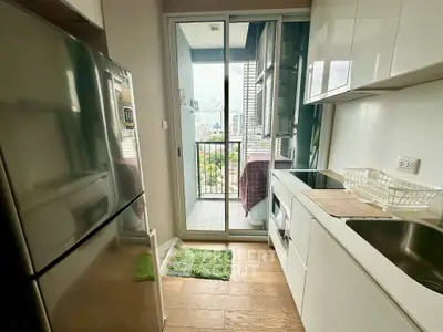 Modern kitchen with balcony view in high-rise apartment