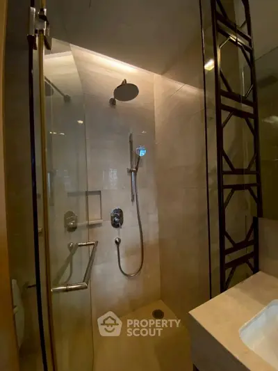 Modern bathroom with glass shower enclosure and sleek fixtures
