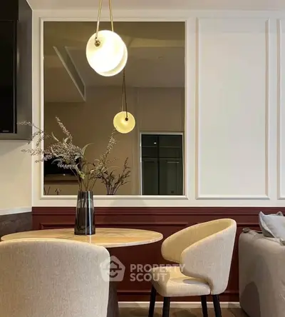 Elegant dining area with modern lighting and stylish decor in a cozy living space.