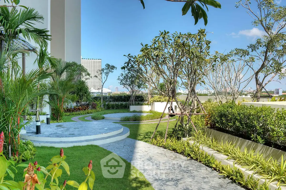 Luxurious garden view with lush greenery and modern landscaping in a high-end residential complex.