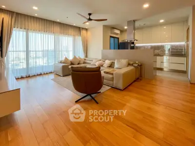Spacious modern living room with open kitchen and large windows
