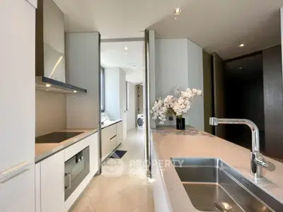 Modern kitchen with sleek design, featuring built-in appliances and elegant countertops.