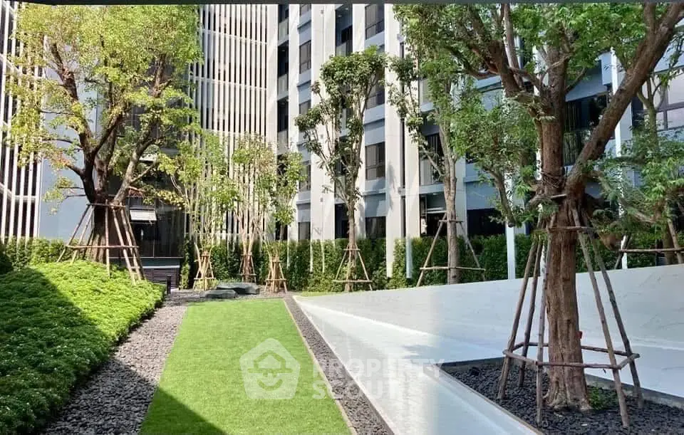 Modern building exterior with lush garden and sleek design