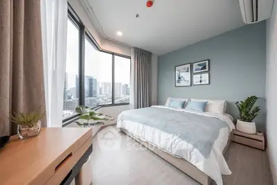 Spacious modern bedroom with large windows and city view, featuring stylish decor and cozy ambiance.