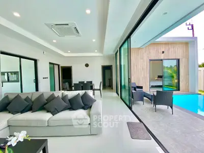 Luxurious modern living room with pool view and sleek interior design