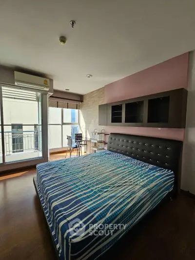 Spacious bedroom with modern decor and natural light in urban apartment