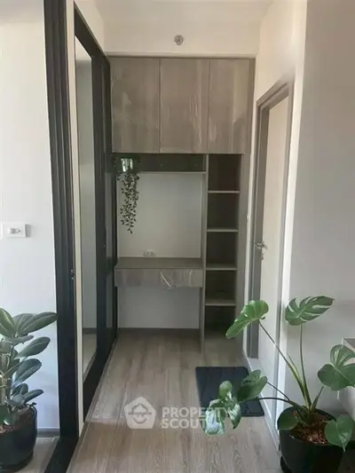 Modern hallway with built-in storage and stylish decor plants