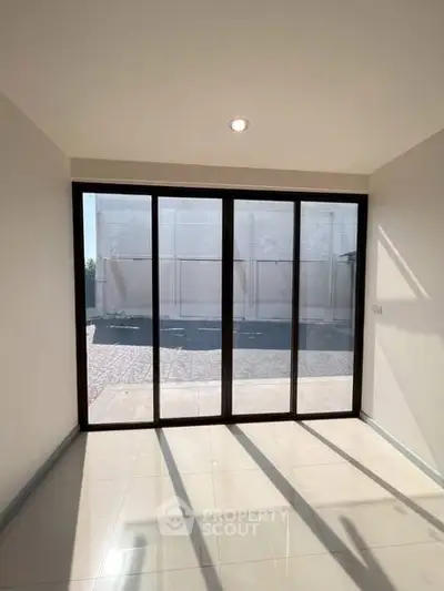 Bright room with large sliding glass doors leading to a patio, perfect for natural light.
