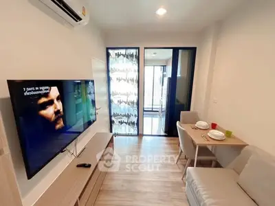 Modern living room with TV, dining area, and balcony access in a stylish apartment.