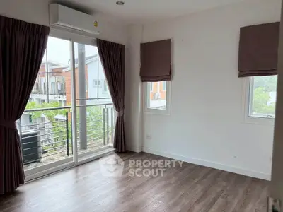 Spacious room with large windows and balcony access in modern apartment