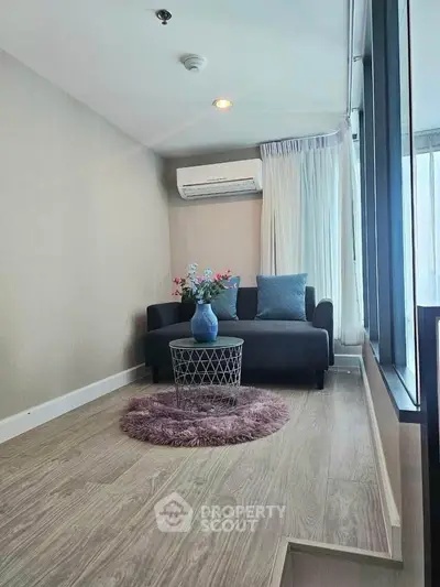 Chic modern living room with cozy sofa and stylish decor in a bright apartment.