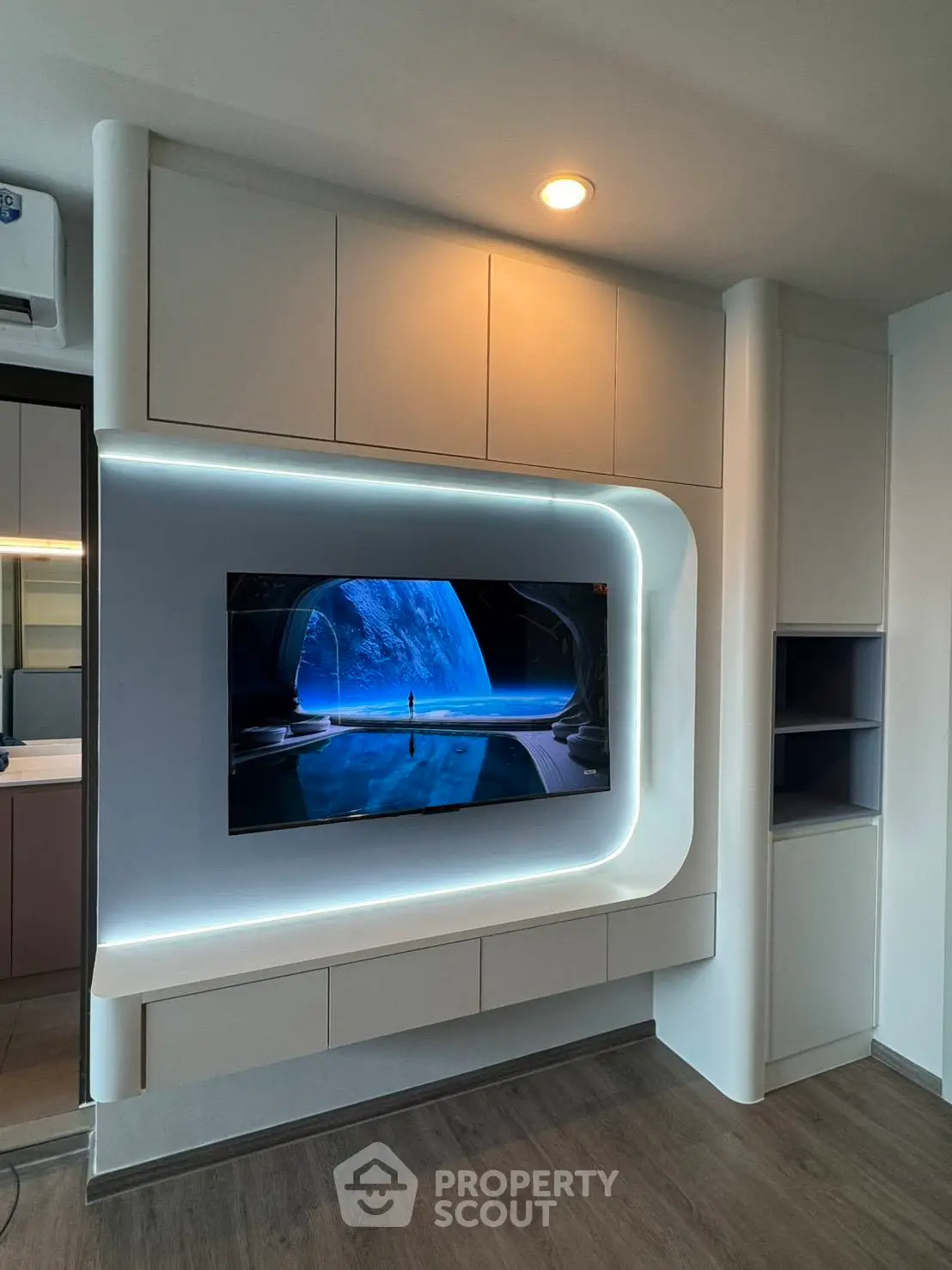 Modern living room with sleek built-in entertainment unit and ambient lighting