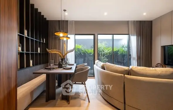 Modern living room with elegant decor and large windows opening to a lush garden view.