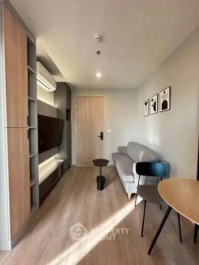 Modern living room with sleek furniture and natural light, perfect for urban living.