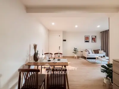 Spacious open-plan living and dining area with modern decor and natural light.