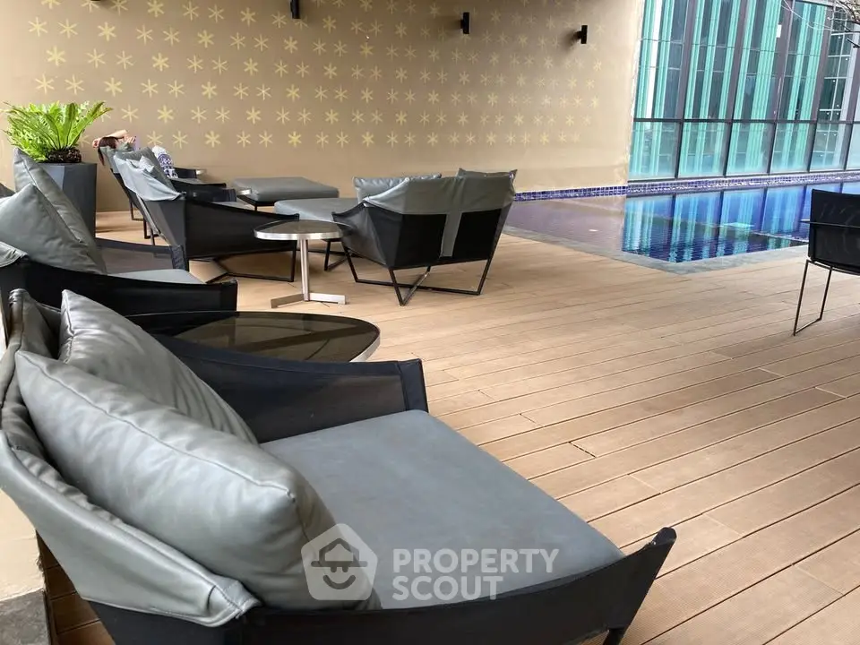 Luxurious poolside seating area with modern chairs and a sleek pool, perfect for relaxation and leisure.