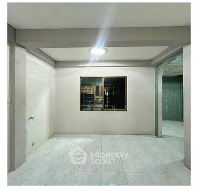 Spacious interior with tiled flooring and open kitchen layout, ideal for modern living.