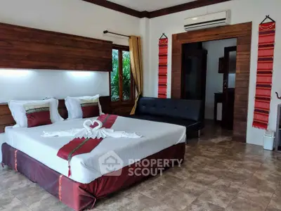 Luxurious bedroom with elegant decor and large windows offering natural light