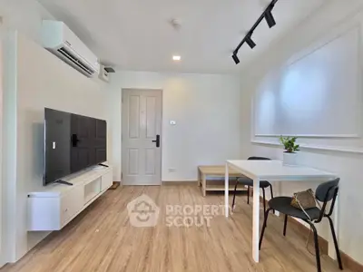 Modern living room with sleek furniture and wooden flooring