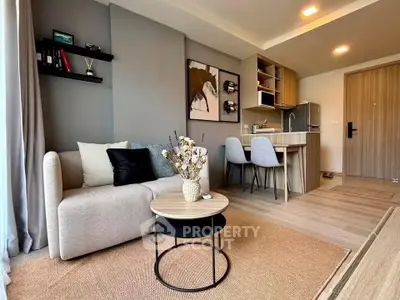 Modern open-plan living room with cozy sofa and stylish kitchen area