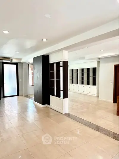 Spacious open-plan living area with modern design and ample natural light