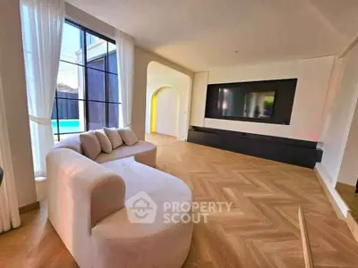 Luxurious modern living room with large TV and elegant seating