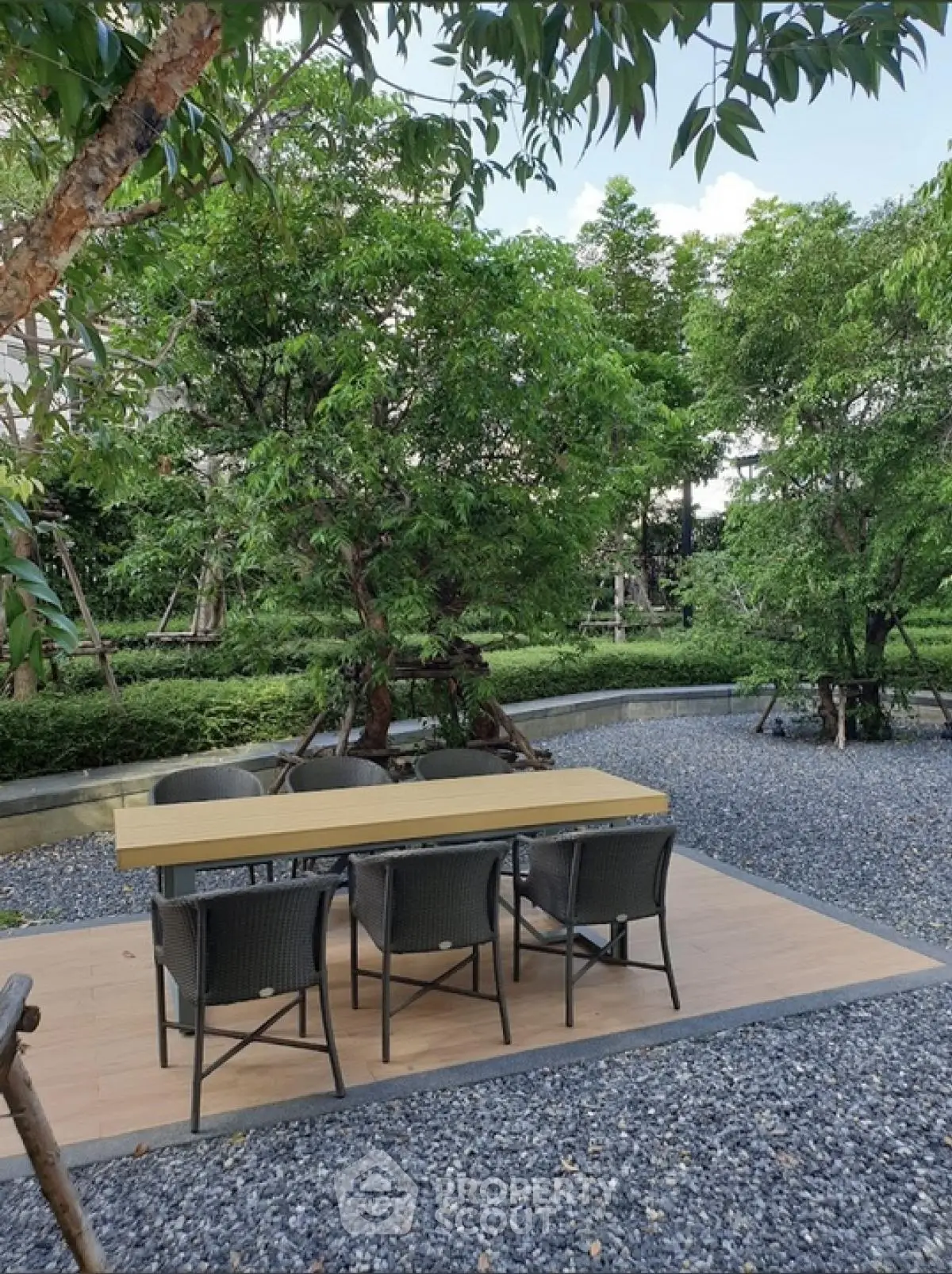 Charming outdoor garden area with modern seating and lush greenery