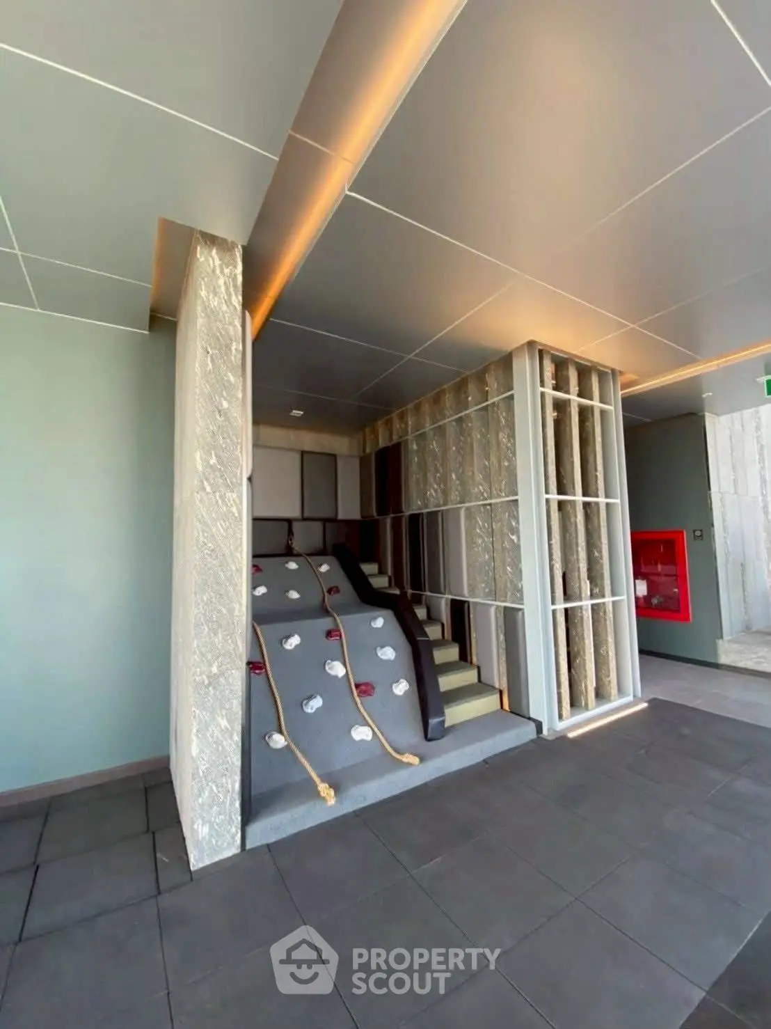 Modern building interior with unique climbing wall feature and sleek design elements.