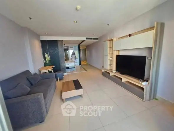Modern living room with sleek furniture and large TV unit