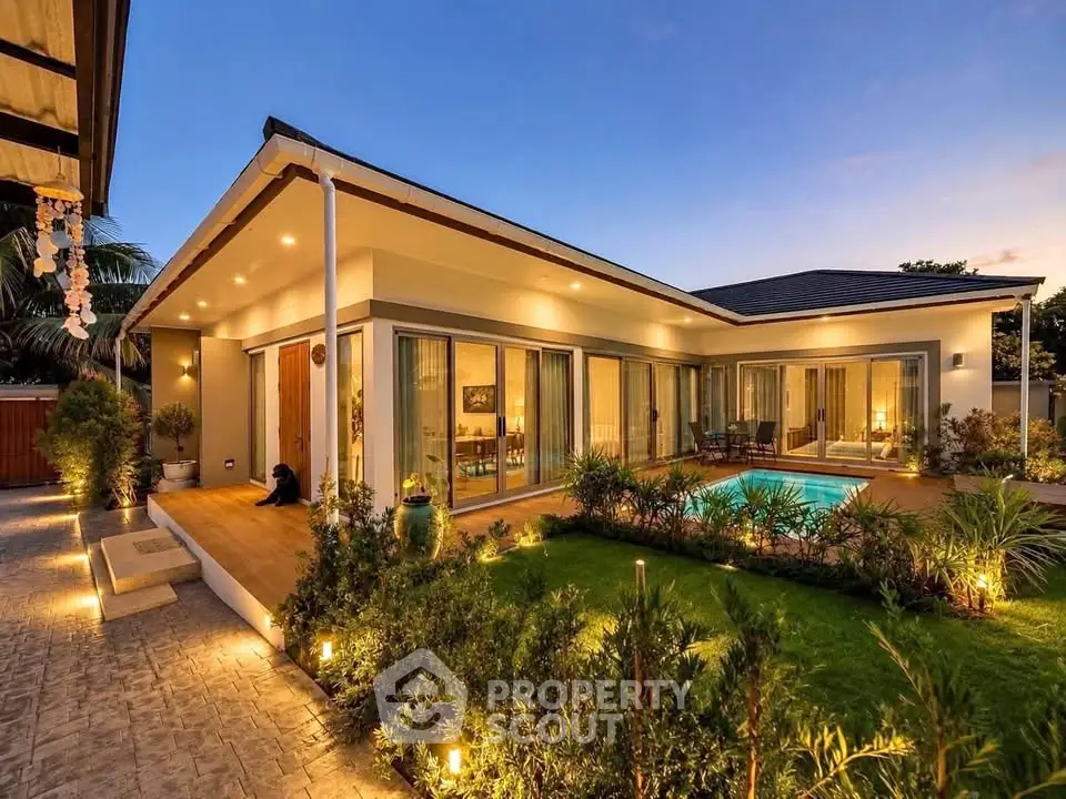 Luxurious modern villa with pool and garden at sunset, perfect for serene living.
