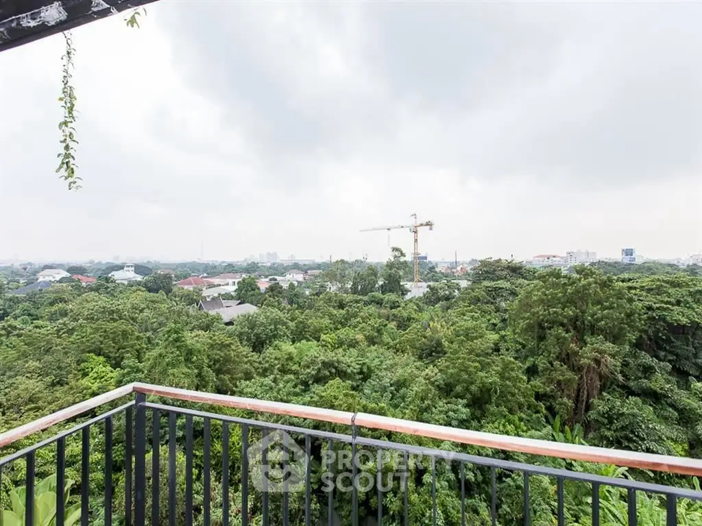 Stunning balcony view overlooking lush greenery and city skyline, perfect for nature lovers seeking tranquility.