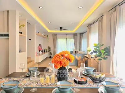 Luxurious open-plan living room with elegant dining setup and vibrant decor