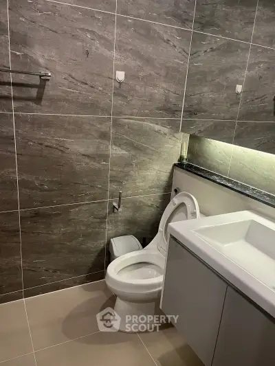 Modern bathroom with sleek tile design and contemporary fixtures.