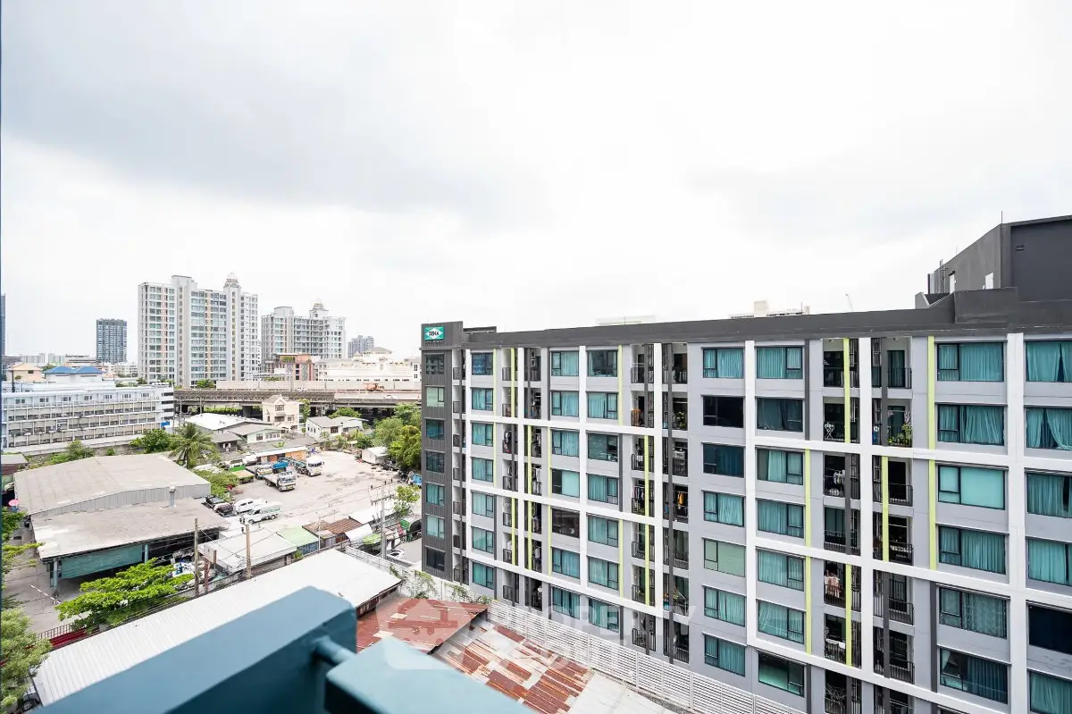 Modern urban apartment building with cityscape view, showcasing contemporary architecture and vibrant surroundings.
