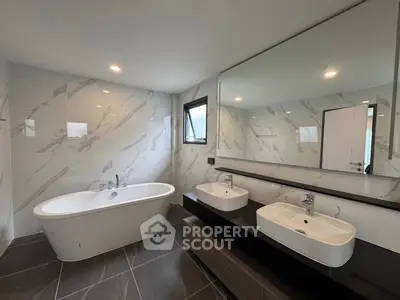 Luxurious modern bathroom with freestanding bathtub and dual sinks