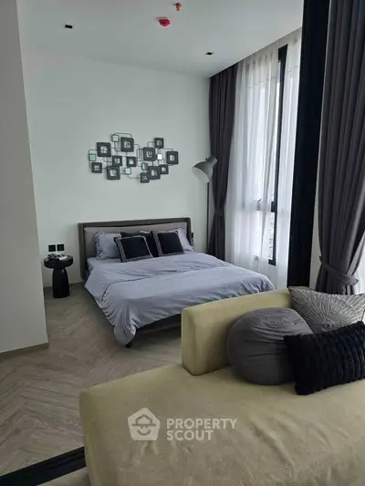 Modern bedroom with stylish decor and large windows in a contemporary apartment.