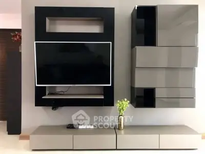 Modern living room with sleek TV unit and stylish storage cabinets.