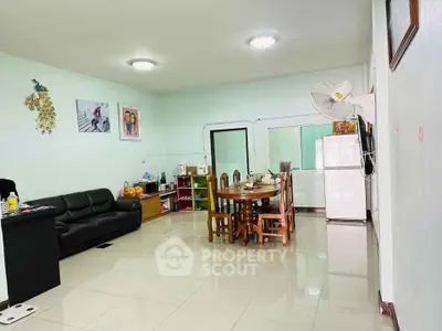 Spacious living room with modern furniture and dining area, perfect for family gatherings.