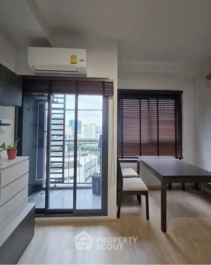 Modern apartment interior with balcony view and dining area