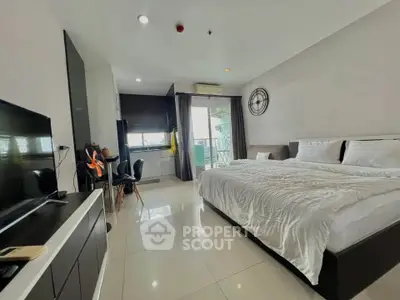 Spacious modern bedroom with balcony and sleek furnishings