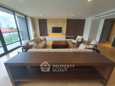 Spacious modern living room with large windows and elegant furniture