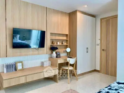 Modern bedroom with built-in wooden furniture and wall-mounted TV