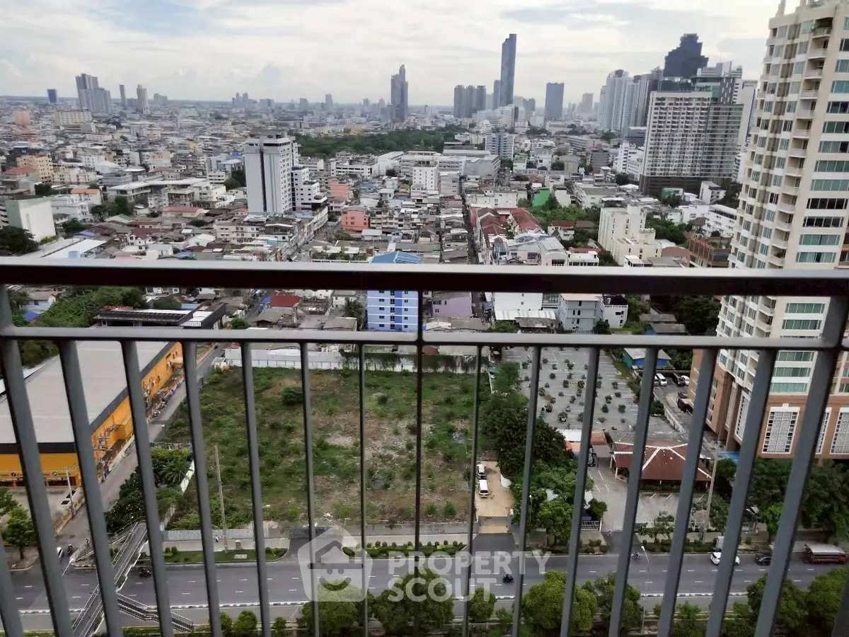 Stunning cityscape view from high-rise balcony overlooking urban skyline and green spaces.