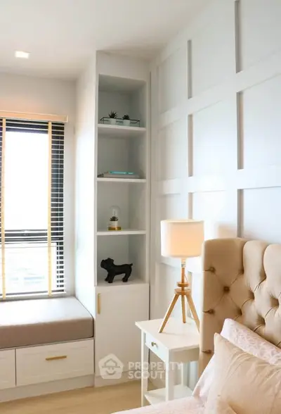 Chic bedroom with elegant panel wall, cozy seating by window, and stylish decor accents.