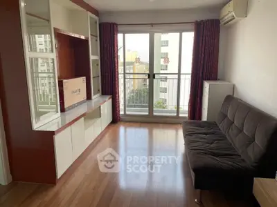 Spacious living room with modern decor and large windows offering city views.