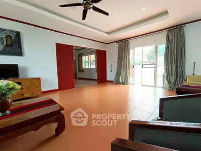 Spacious living room with elegant decor and large windows for natural light.