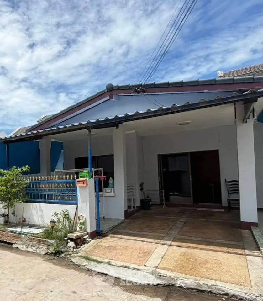 Charming single-story house with covered carport and inviting entrance under a clear blue sky.