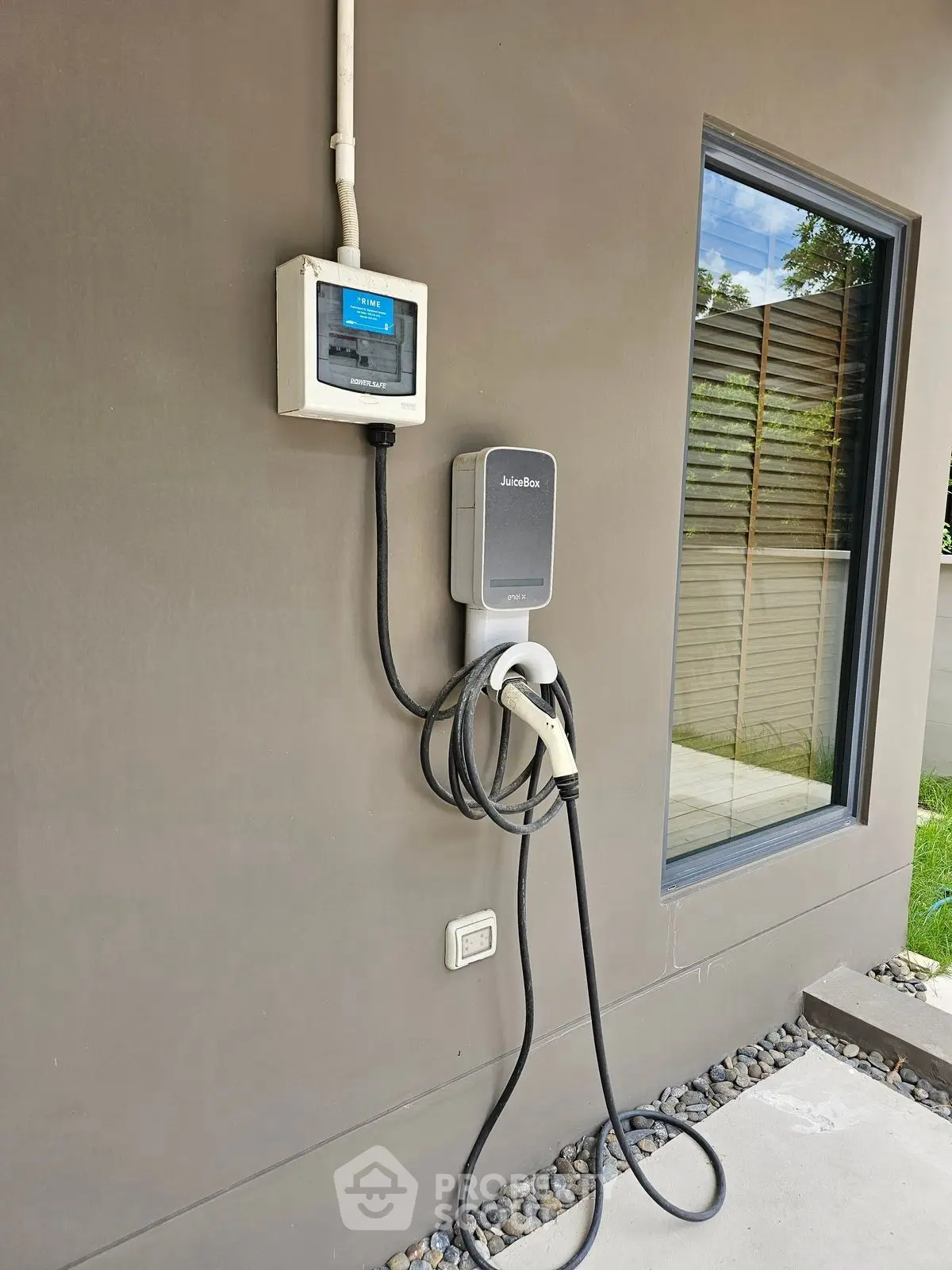 Modern home exterior with electric vehicle charging station installed.