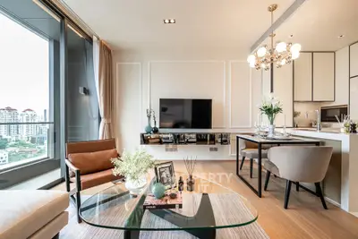 Luxurious modern living room with city view, elegant decor, and open kitchen layout.