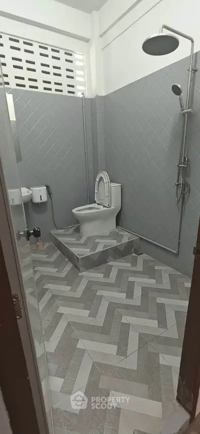 Modern bathroom with stylish gray tile design and sleek shower setup